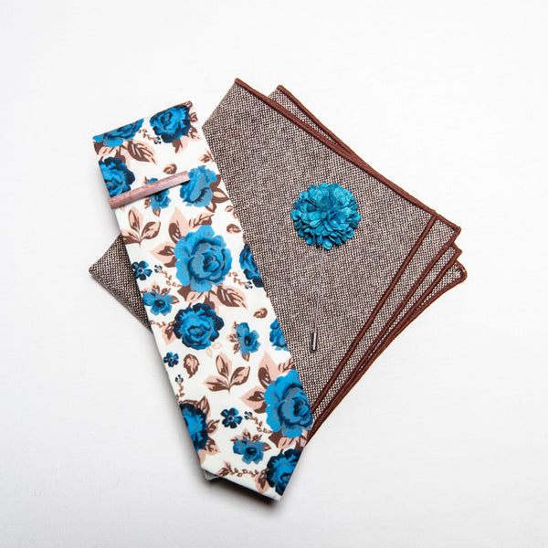 a men's accessories set - The earthy, wood tie bar along with the wool pocket square give rise to the bright, light blue flowers on the lapel pin and the floral tie