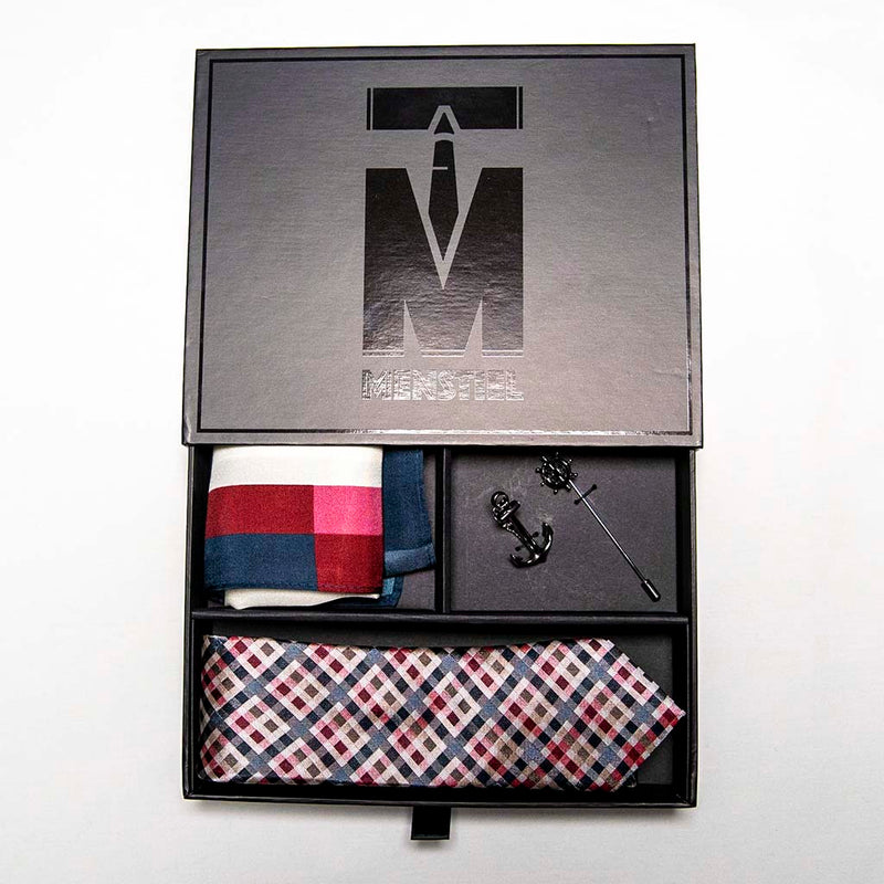 voyage set in box with top in a gift box - The silver helm lapel pin on the breast represents choice, while the anchor tie bar on the chest symbolizes strength. These two coupled with the versatile, multi-colored silk tie and silk pocket square make a great combination 